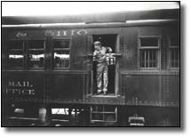 Railway mail clerk preparing to catch mailbag, 1913